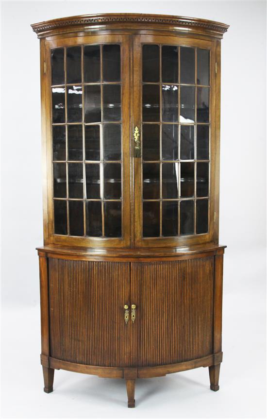 A Regency style mahogany bowfront corner cabinet, W.3ft 3in. H.6ft 4in.